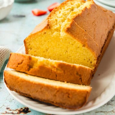 square image of pound cake with a few slices cut from the front of the loaf