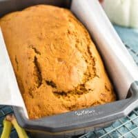 square image of a baked loaf of pumpkin banana bread in a loaf pan