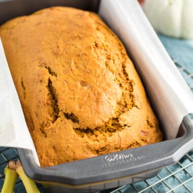 square image of a baked loaf of pumpkin banana bread in a loaf pan