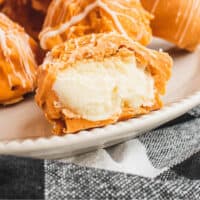 pumpkin cheesecake balls on a plate with recipe name at the bottom