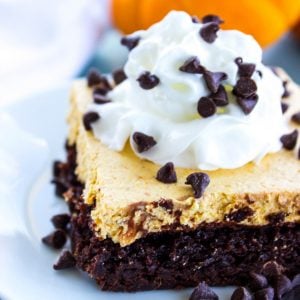 Pumpkin Cheesecake Brownie Bars are topped with a pumpkin no-bake cheesecake then finished off with whipped topping and mini chocolate chips. This is an easy fall must-have!