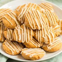 square image of pumpkin cookies topped with a drizzle of maple frosting