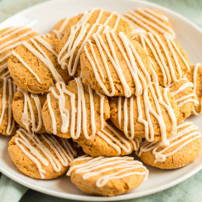 square image of pumpkin cookies topped with a drizzle of maple frosting