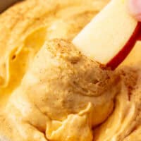 pumpkin mousse dip on an apple slice after being dipped