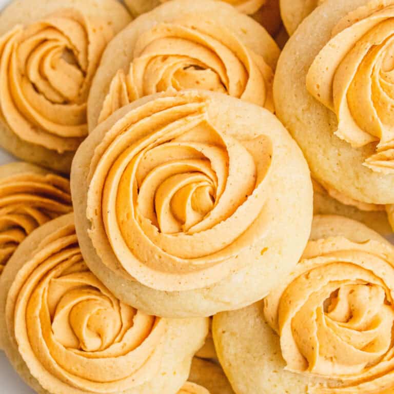 square image of pumpkin spice sugar cookies piled on a plate