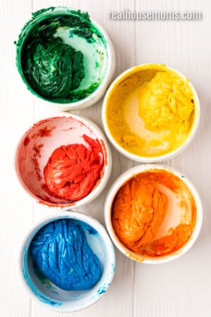 cake mix cookie dough divided into 5 bowls, each a different color