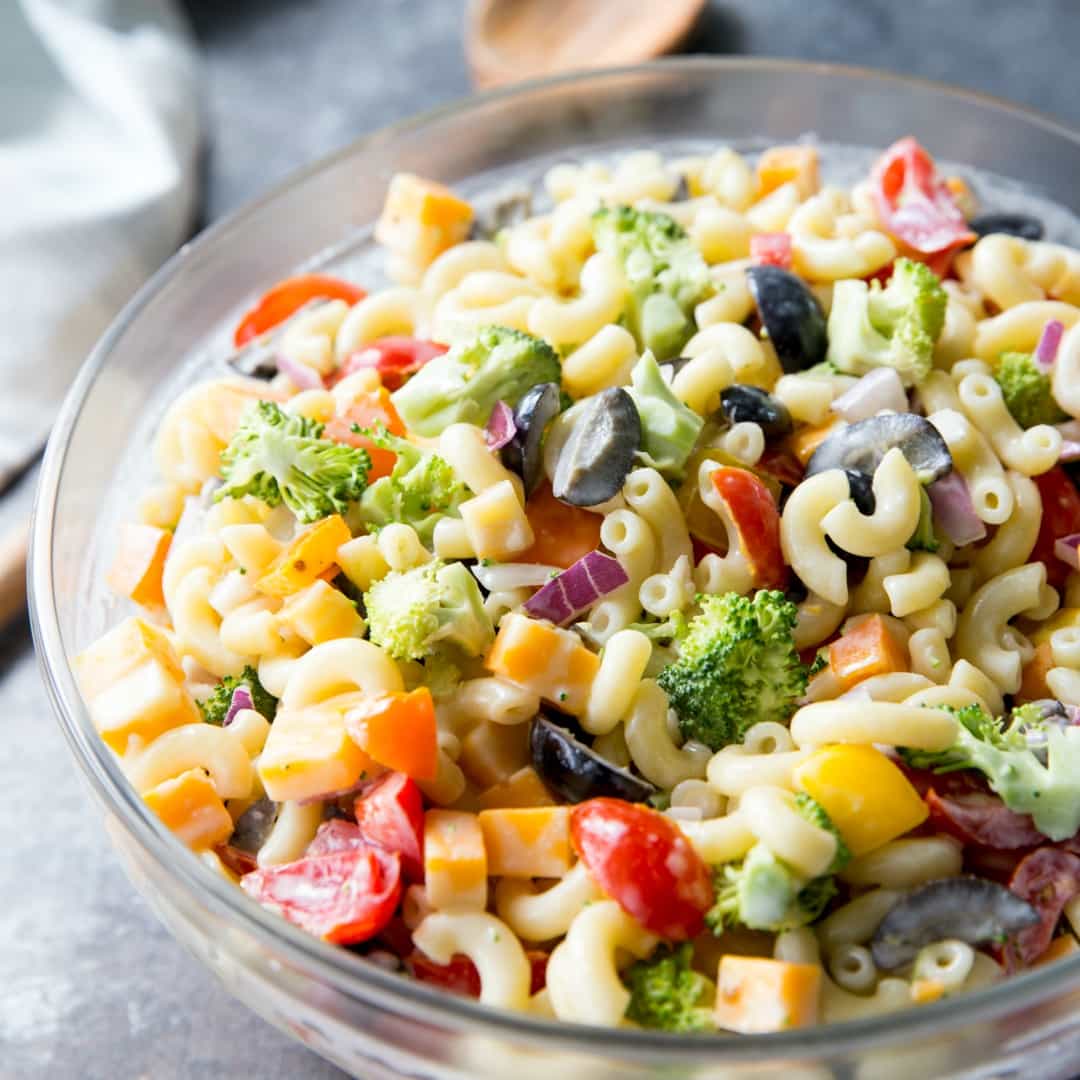 Easy Rainbow Macaroni Salad is a delicious pasta salad studded with rainbow-colored veggies to make a fun, delicious summer side. We eat this macaroni salad all year long!