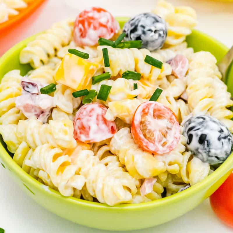 square image of ranch pasta sald in a small bowl with a fork