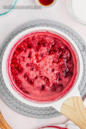 raspberries and water boiling in a saucepan
