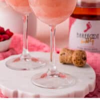 raspberry wine floats in wine glasses with recipe name at the bottom