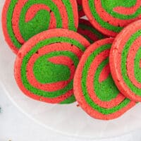 red & green pinwheel cookies on a plate with recipe name at the bottom