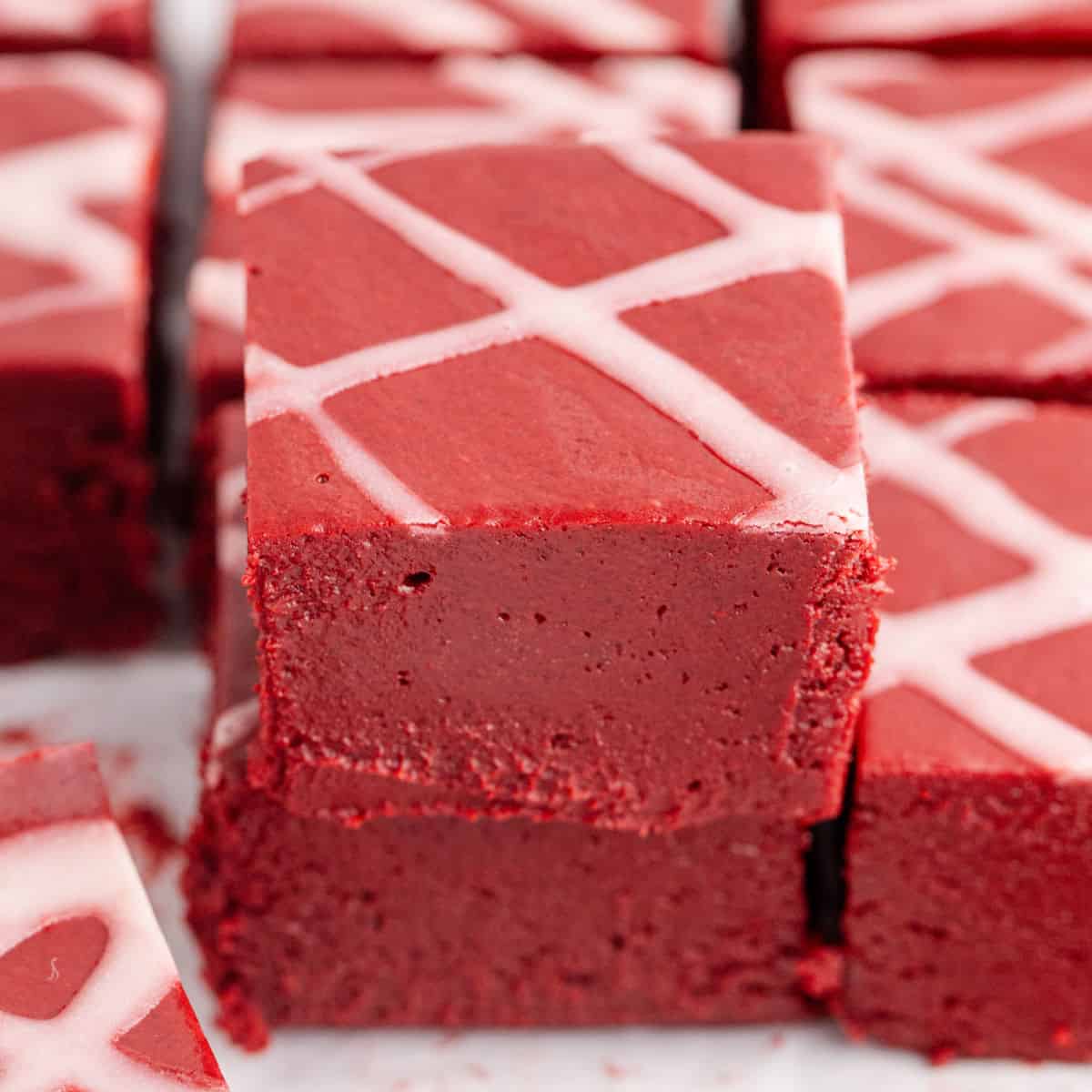 square image of two squares of red velvet fudge stacked up