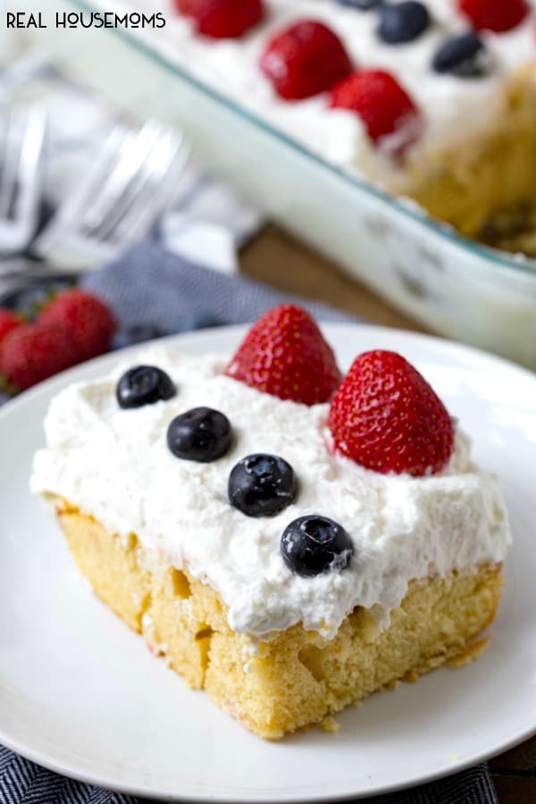 Red, White and Blue Cheesecake Poke Cake is a super easy dessert recipe that is perfect for celebrating the Fourth of July!