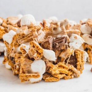 square image of a reese's peanut butter cup s'mores bars on a marble platter