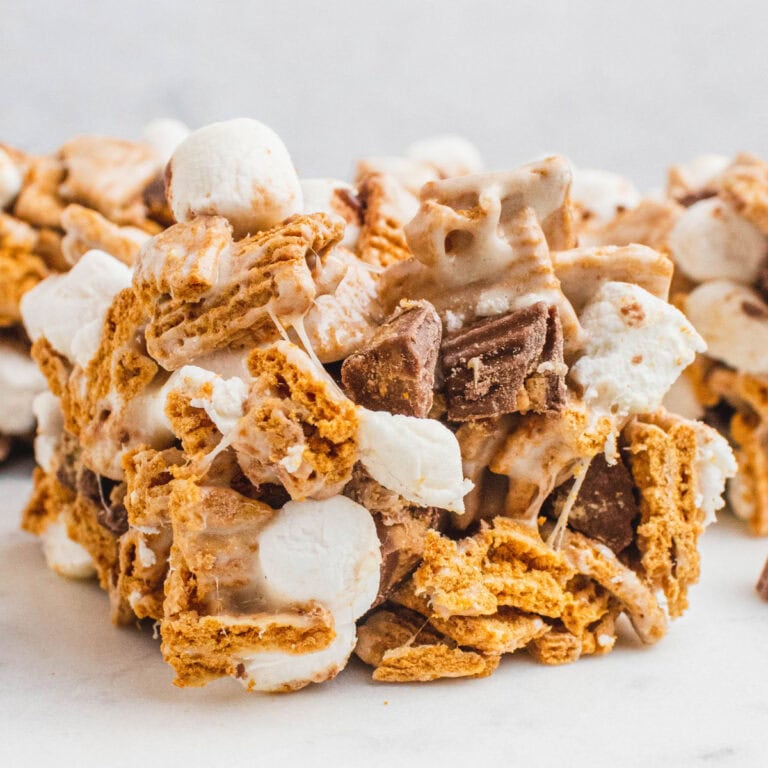 square image of a reese's peanut butter cup s'mores bars on a marble platter