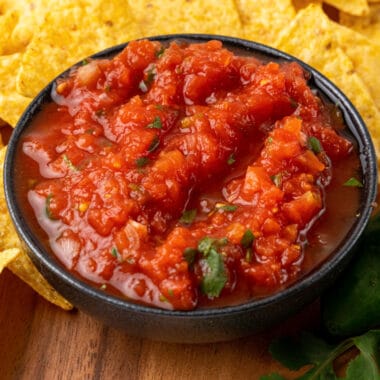 square image of restaurant style salsa in a bowl surround by tortilla chips