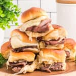 square image of roast beef horseradish cheddar sliders stacked on a plate
