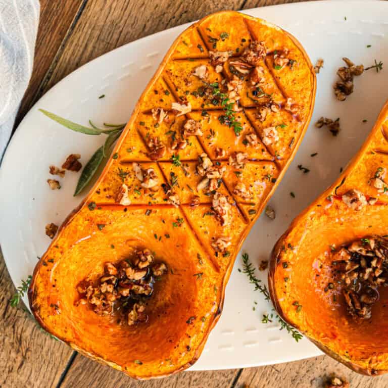 square image of roasted butternut squash halves on a platter