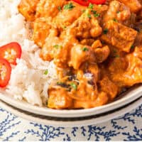 roasted vegetable curry in a bowl with rice with recipe name at the bottom