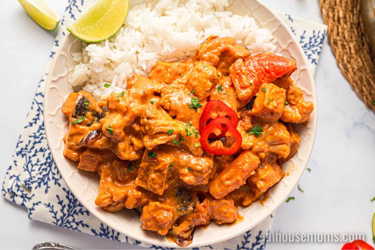 looking down at a bowl of roasted vegetable curry served over white rice