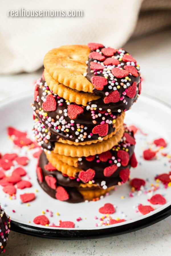 chocolate dipped rolo stuffed ritz crackers with valentine's day sprinkles