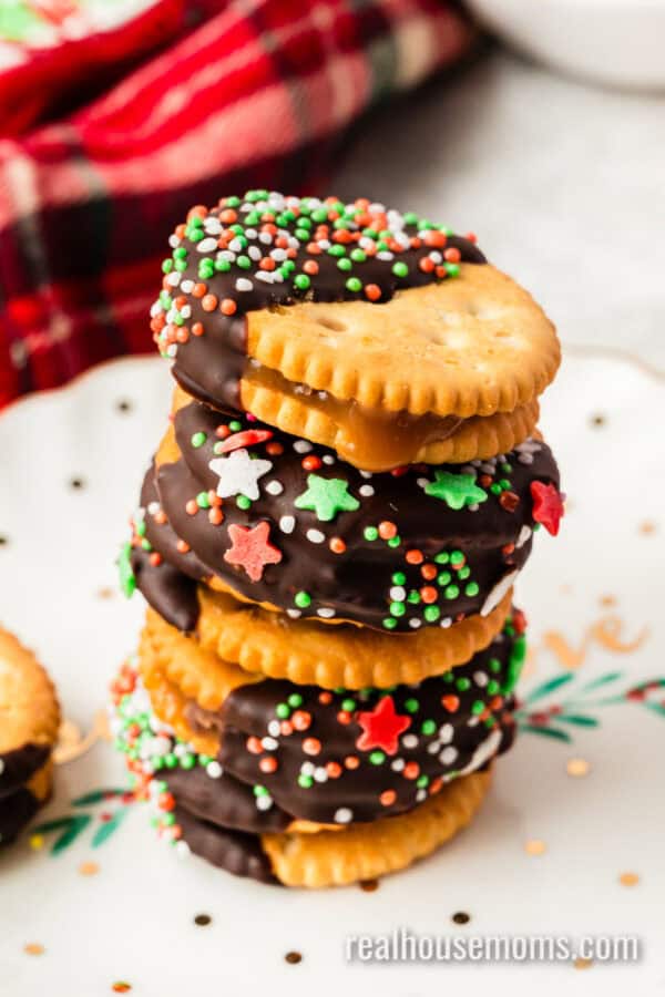 chocolate dipped rolo stuffed ritz crackers with christmas sprinkles