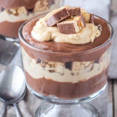 square image of chocolate pfarait in dessert cups with peanut butter and candy bars