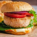 square image of a salmon burger on a cutting board