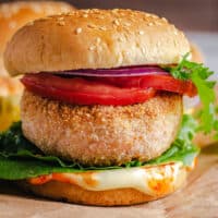 square image of a salmon burger on a cutting board