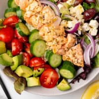 looking down at a salmon salad in a serving bowl with recipe name at the bottom