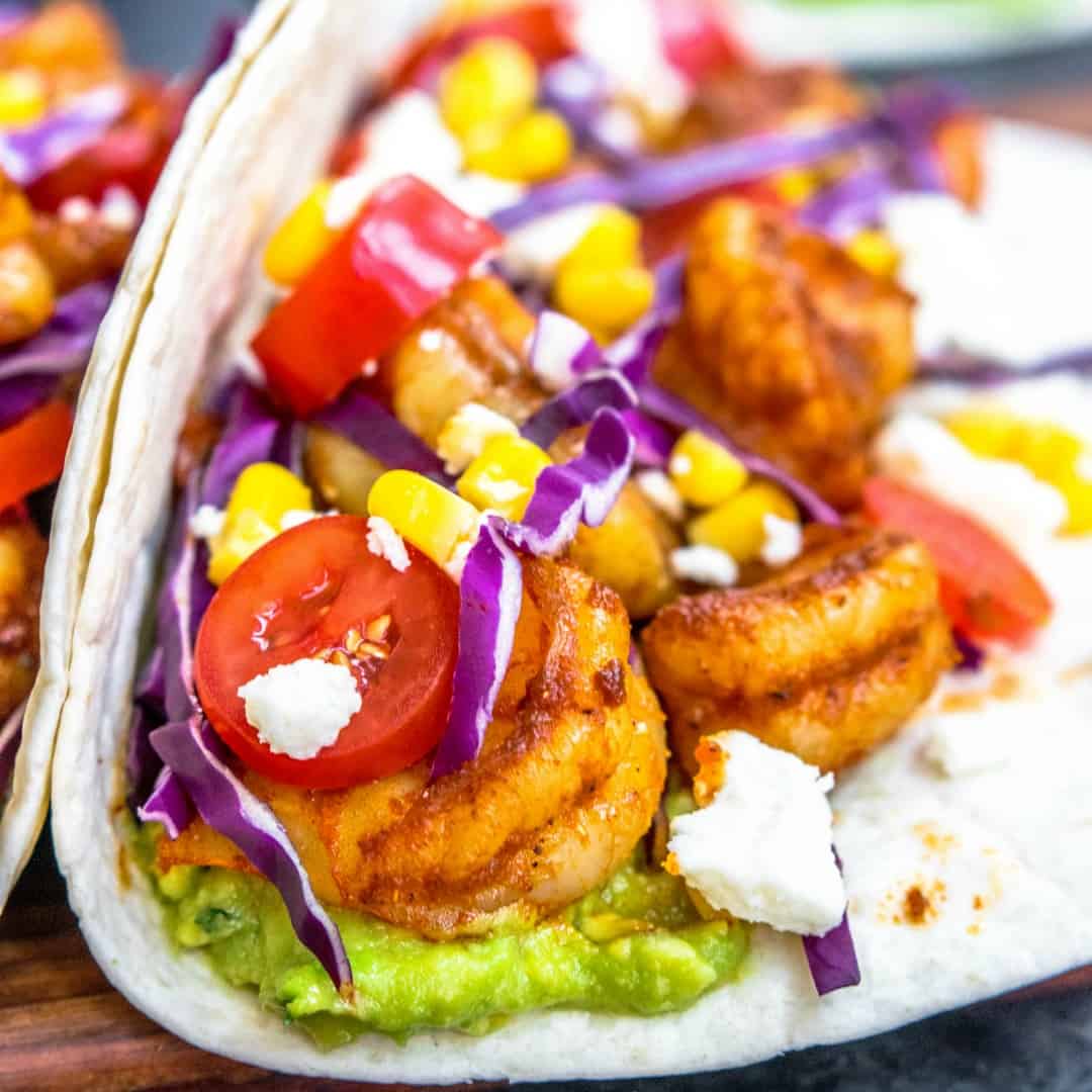 Salsa Verde Shrimp Taco Recipe is spicy shrimp and a colorful, crunchy, combination of your favorite taco toppings served in a soft flour tortilla. It's an easy recipe for Cinco de Mayo that can be made in 30 minutes or less!