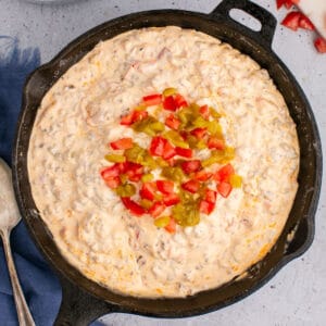 square image looking down at a skillet of sausage cream cheese dip