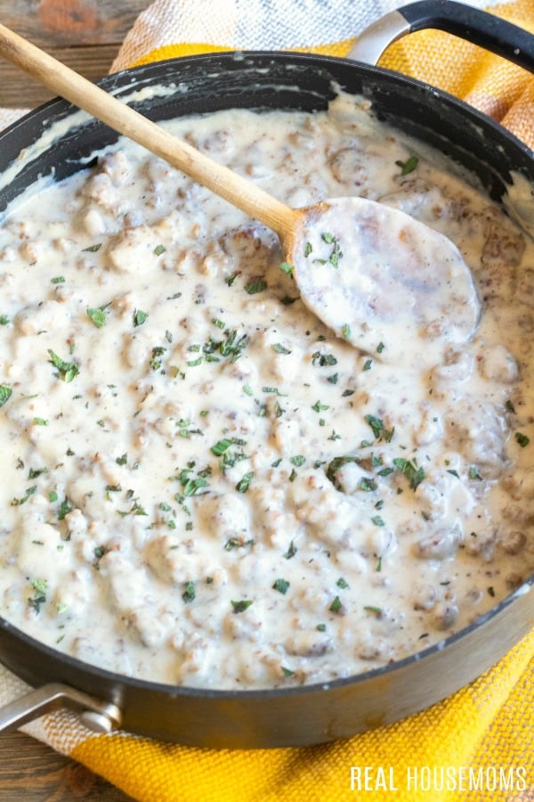 sausage gravy in a skillet with chopped sage