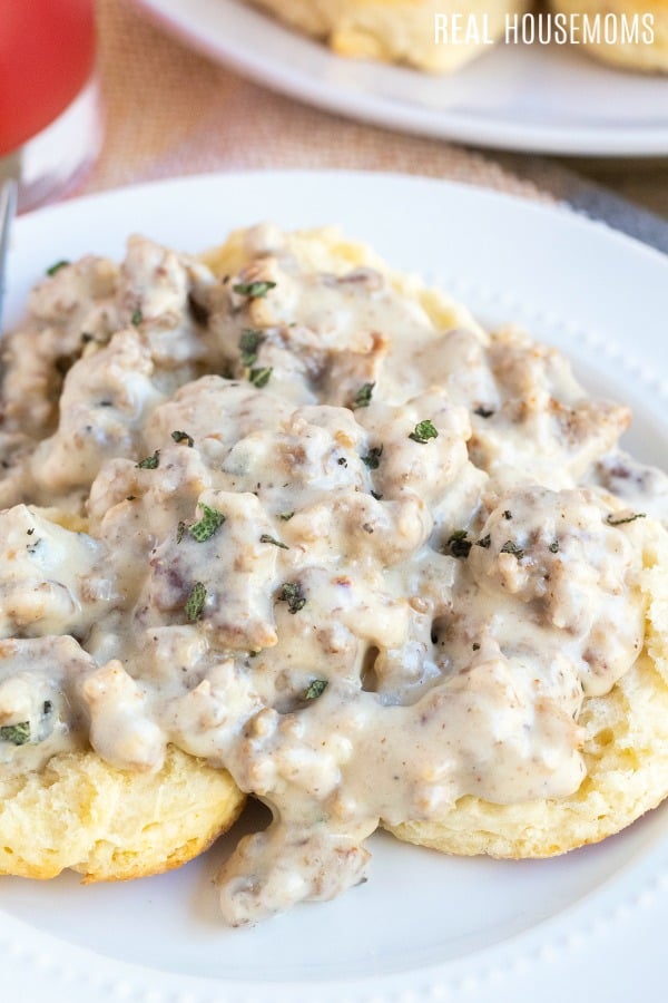 close up photo of sausage gravy over biscuits