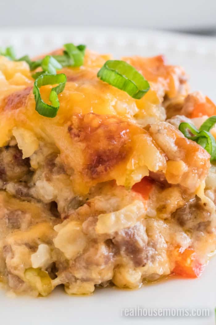 clode up of sausage hash brown casserole topped with green onion