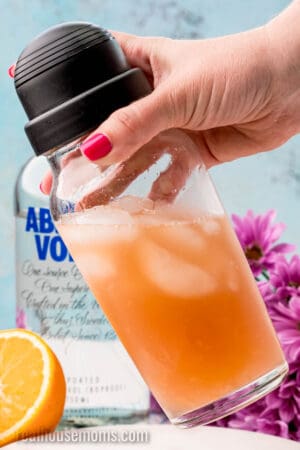 cocktail shaker with spirits and juice being shaken