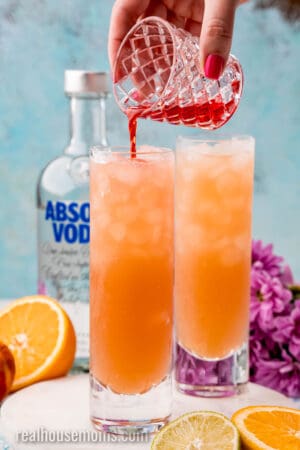 grenadine being poured over sex on the beach cocktails