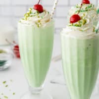 square image of 3 shmrock shakes with whipped cream and a cherry