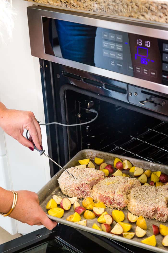 beko oven meat thermometer being inserted into pork chops