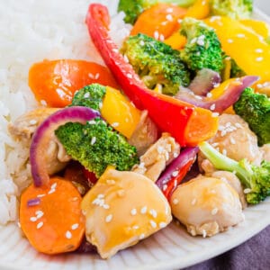 square image of orenage teriyaki chicken and vegetables over white rice