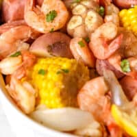 low-country shrimp boil in an oval dish wtih recipe name at the bottom