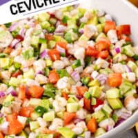 square image of shrimp ceviche in a serving bowl with gold serving spoons with the title of the post on top of the left corner
