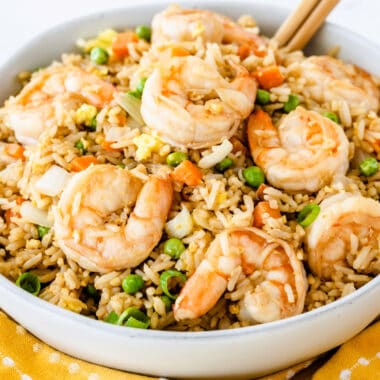square image of shrimp fried rice in a bowl with chopsticks