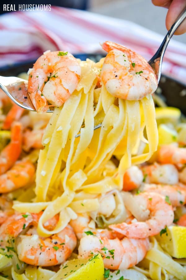 forks lifting shrimp scampi and pasta for serving