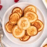 square image looking down at silver dollar pancakes piled on a plate