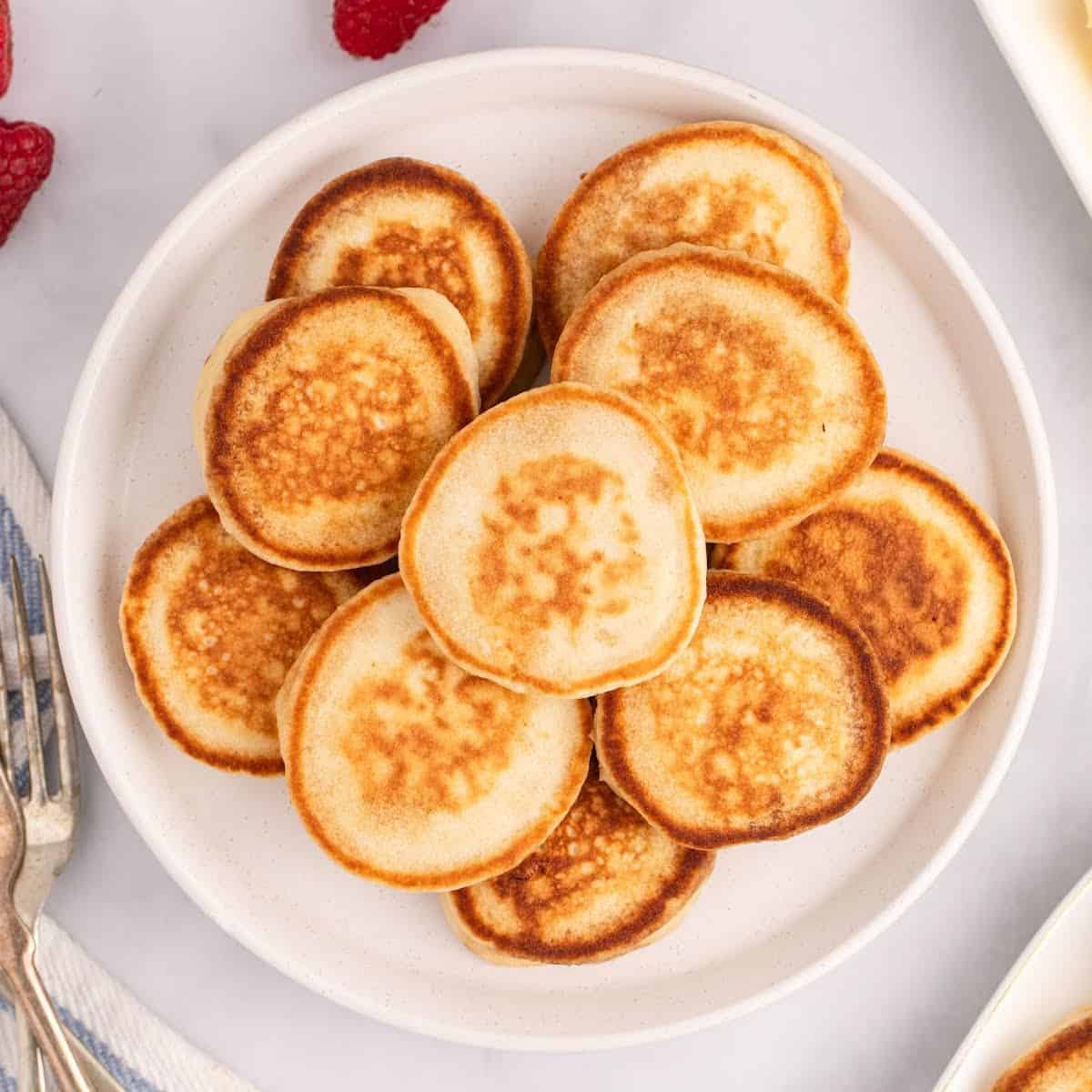 square image looking down at silver dollar pancakes piled on a plate