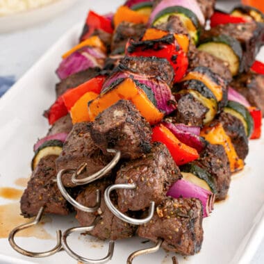 square image of sirloin shish kabobs piled on a paltter