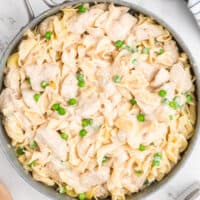 square image of creamy chicken noodle casserole in a skillet