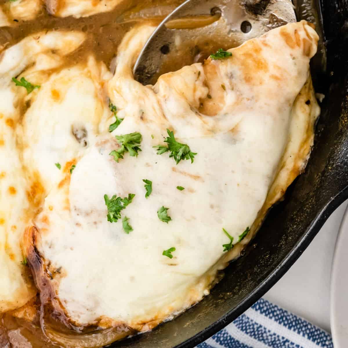 square close up of french onion chicken in a skillet