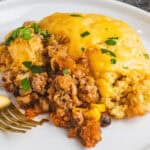 square image of a portion of skillet turkey cornbread casserole on a plate